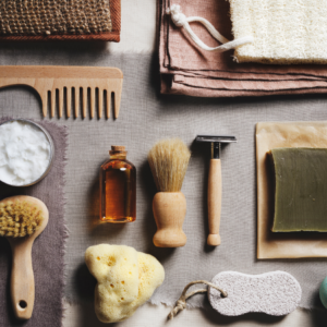 "Flat lay of men's grooming tools including comb, razor, shaving brush, and soap."