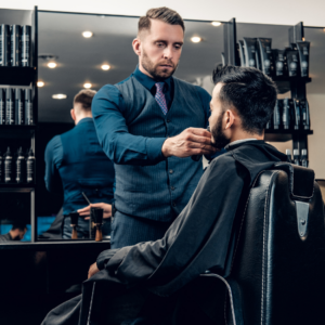 "Barber grooming a client's beard in a stylish barber shop."